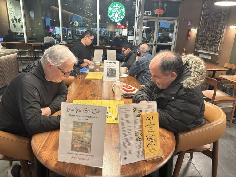 Evanston Go Club founder Mark Rubenstein (left) plays during a Wednesday night club meeting at Starbucks near Northwestern University. Photo by Maya Heyman/The Daily Northwestern. Source: https://dailynorthwestern.com/2026/01/14/city/evanston-go-club-marks-30-years-of-community-and-competition/.