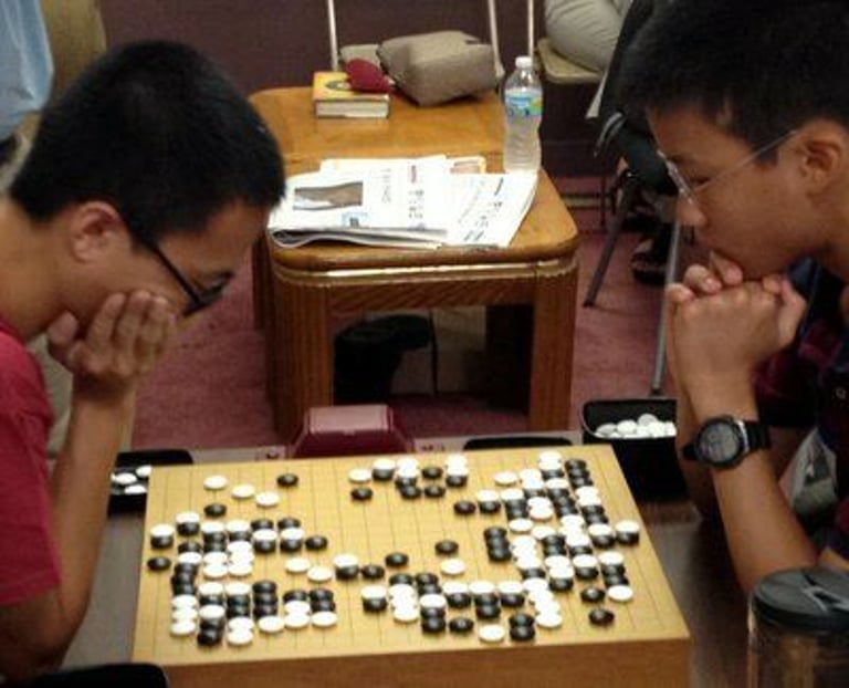 Twelve-year-old Albert Yen 6D (right) plays Changyu Han at the Sept. 1, 2012, “Me Tarzan” tournament in Chicago. Yen finished undefeated to take first place in the Dan division. Photo by Mark Rubenstein. Source: https://aga-news-archive-viewer.azurewebsites.net/api/news-archive/article/6247.